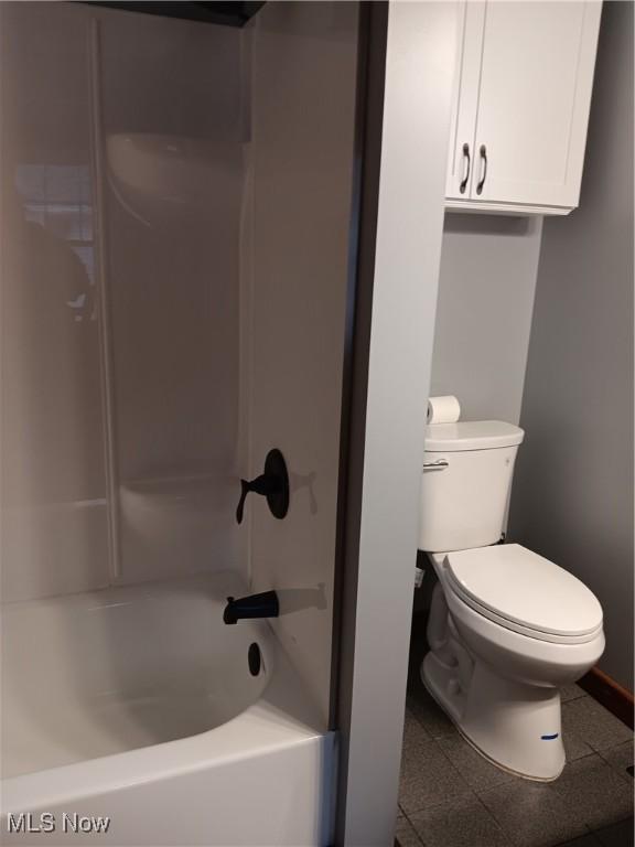 bathroom featuring bathing tub / shower combination and toilet