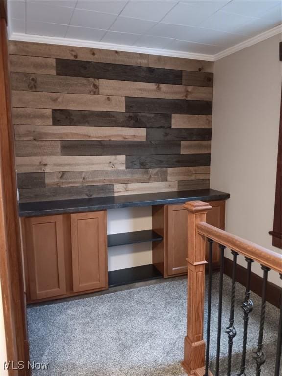 bar with crown molding, carpet, and wood walls