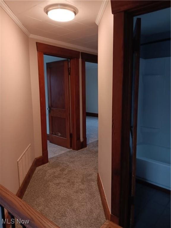 hall with crown molding and carpet floors