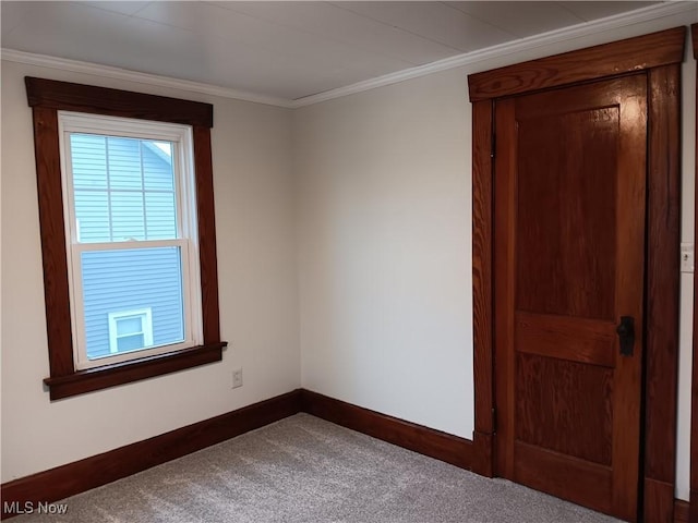 carpeted spare room with crown molding