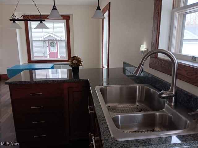 kitchen with sink, pendant lighting, and dark brown cabinetry