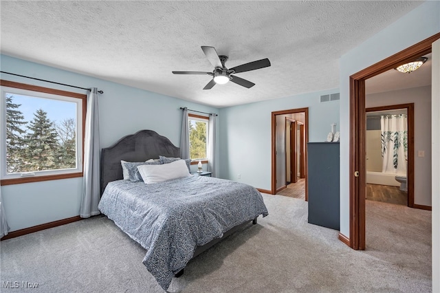 carpeted bedroom with visible vents, ceiling fan, a textured ceiling, and baseboards