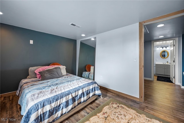 bedroom with recessed lighting, visible vents, baseboards, and wood finished floors