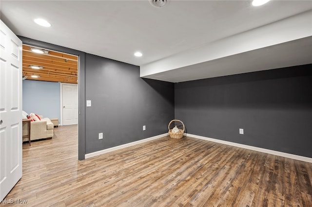 finished below grade area featuring recessed lighting, wood finished floors, and baseboards