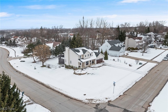 snowy aerial view featuring a residential view