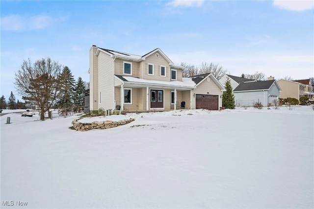 view of property with a garage and a porch