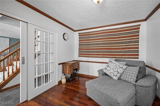 sitting room with baseboards, ornamental molding, stairs, hardwood / wood-style flooring, and a textured ceiling