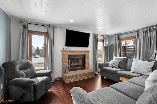 living room featuring baseboards, recessed lighting, a fireplace, wooden ceiling, and wood-type flooring