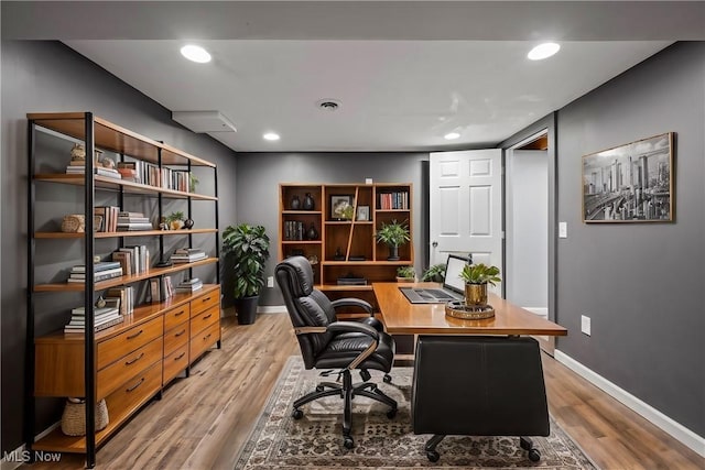 office featuring recessed lighting, visible vents, baseboards, and light wood-style floors