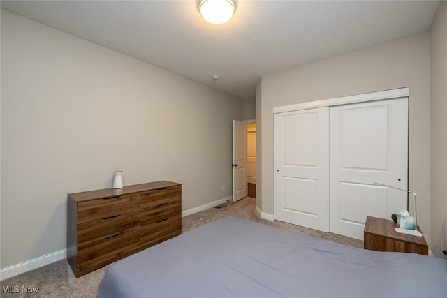 carpeted bedroom featuring a closet