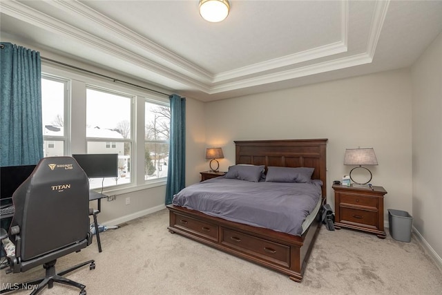 carpeted bedroom featuring a raised ceiling and ornamental molding