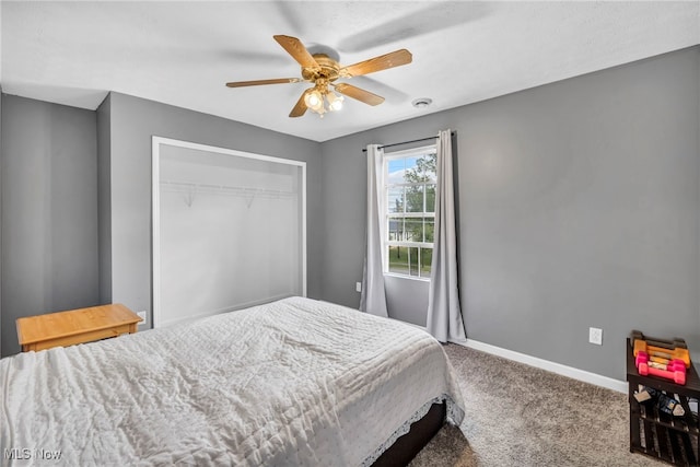 carpeted bedroom featuring a closet and ceiling fan