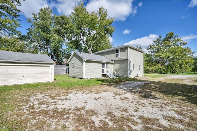 exterior space featuring a garage and an outbuilding