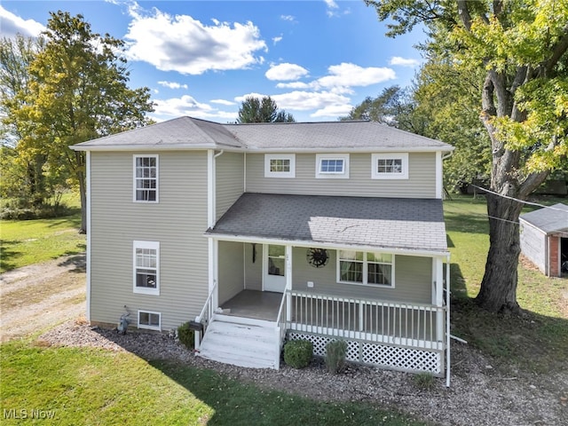 front of property with covered porch and a front lawn