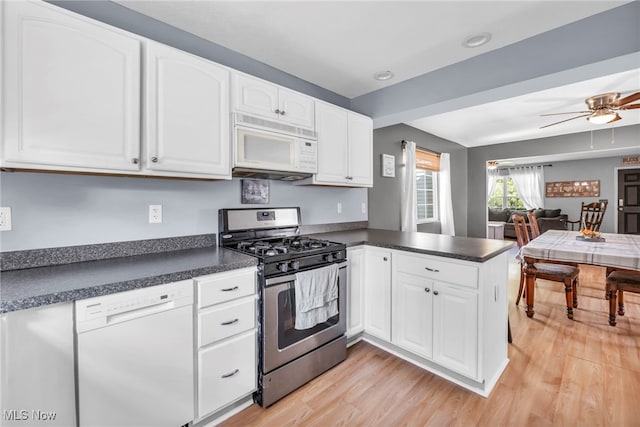 kitchen with white cabinetry, light wood-type flooring, white appliances, and kitchen peninsula