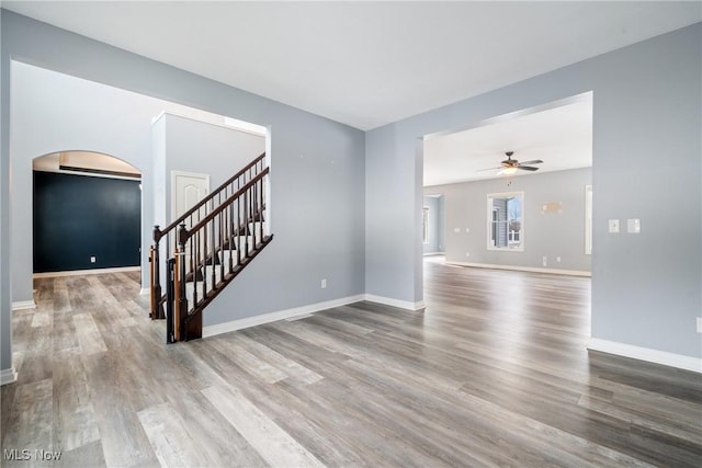 unfurnished living room featuring hardwood / wood-style flooring and ceiling fan