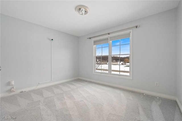 spare room with light colored carpet