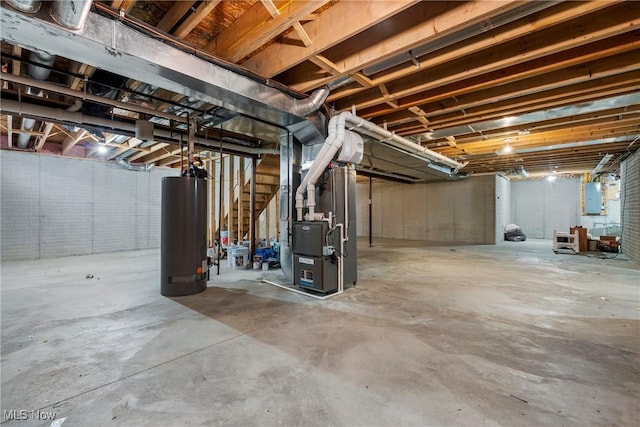 basement with electric panel, heating unit, and gas water heater