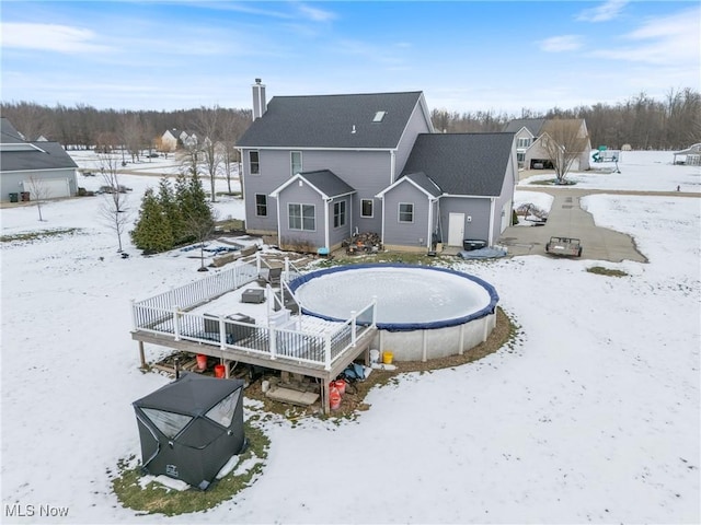 snow covered house featuring a deck