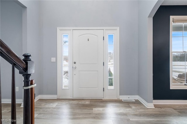 foyer featuring plenty of natural light and light hardwood / wood-style floors