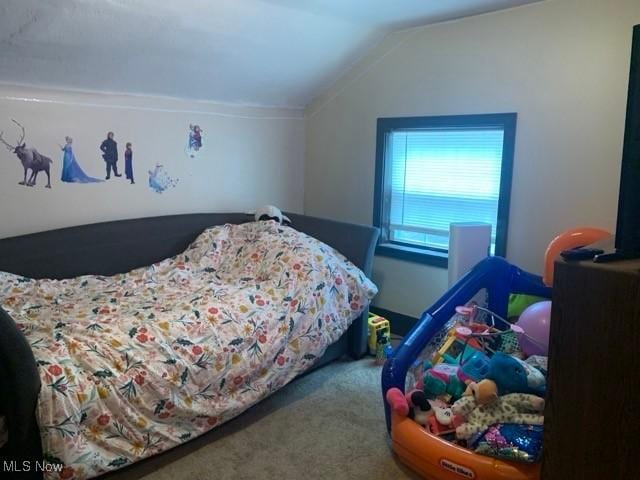 bedroom featuring lofted ceiling and carpet flooring