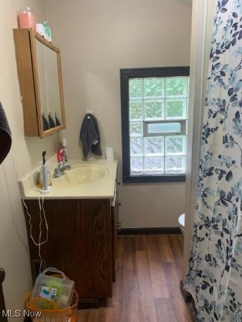 bathroom with vanity, hardwood / wood-style flooring, and toilet