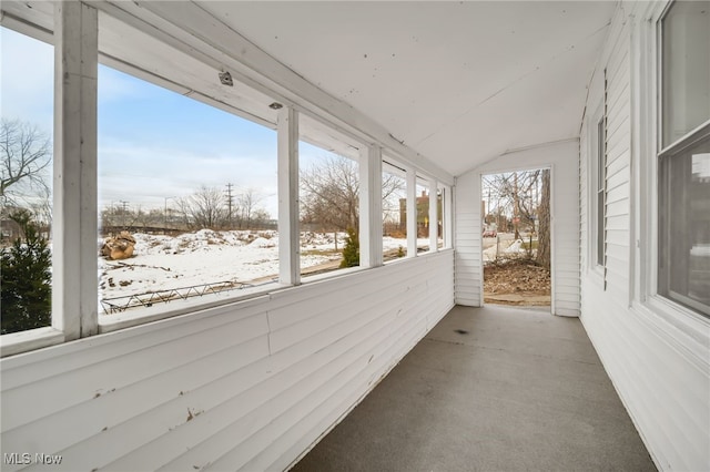 unfurnished sunroom featuring lofted ceiling