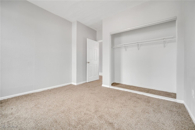 unfurnished bedroom featuring carpet and a closet