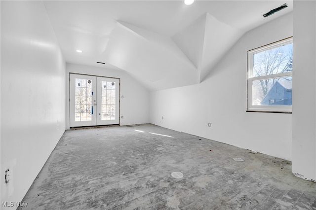 additional living space with plenty of natural light, lofted ceiling, and french doors