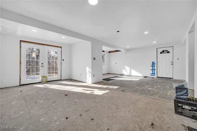 unfurnished living room featuring french doors