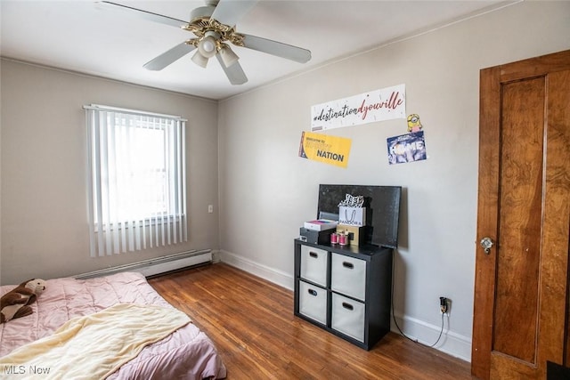 bedroom featuring ceiling fan, a baseboard heating unit, and dark hardwood / wood-style flooring