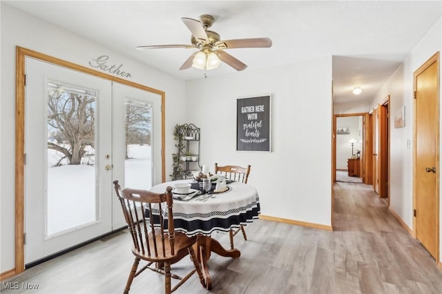 dining space with light hardwood / wood-style floors, french doors, and a healthy amount of sunlight