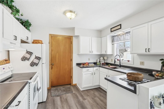 kitchen with sink, light hardwood / wood-style floors, white cabinets, and white range with electric stovetop