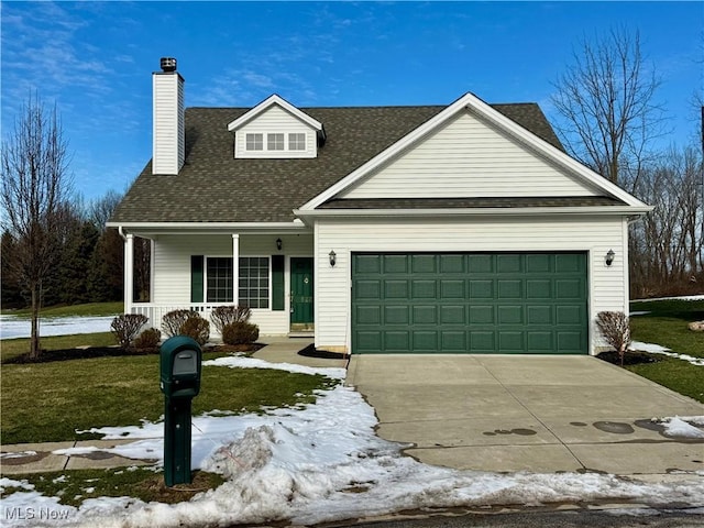 view of front facade with a garage, covered porch, and a lawn