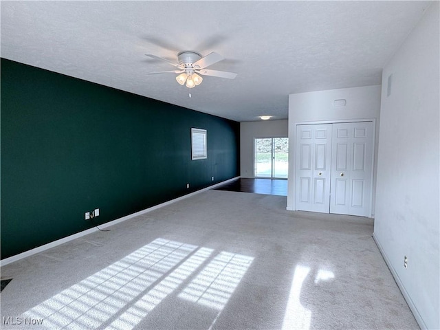 empty room featuring a textured ceiling and ceiling fan