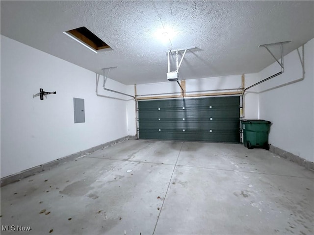 garage with a garage door opener and electric panel