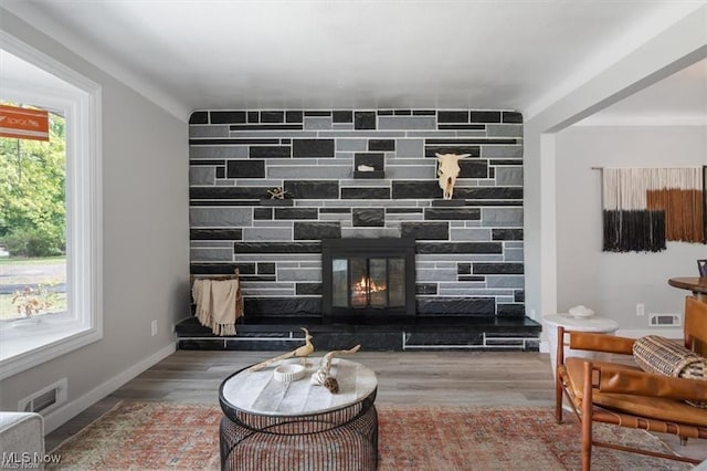 sitting room with a fireplace and hardwood / wood-style floors