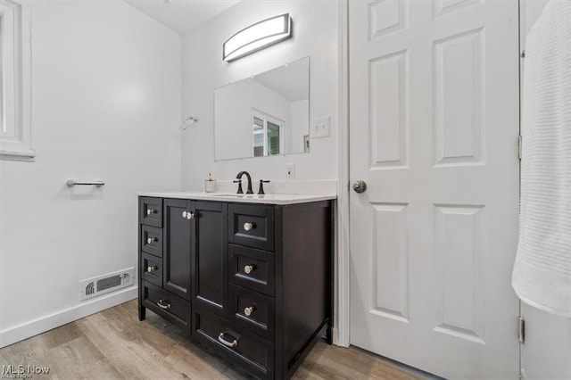 bathroom featuring vanity and hardwood / wood-style flooring