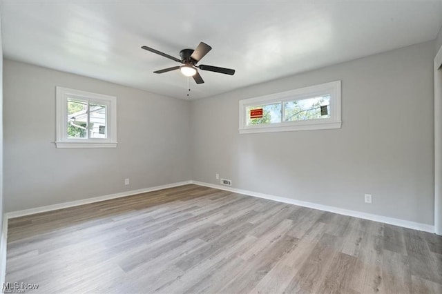 empty room featuring ceiling fan and light wood-type flooring