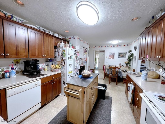 kitchen with white appliances and a textured ceiling