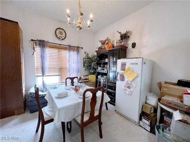 dining space featuring vaulted ceiling, light carpet, and a notable chandelier