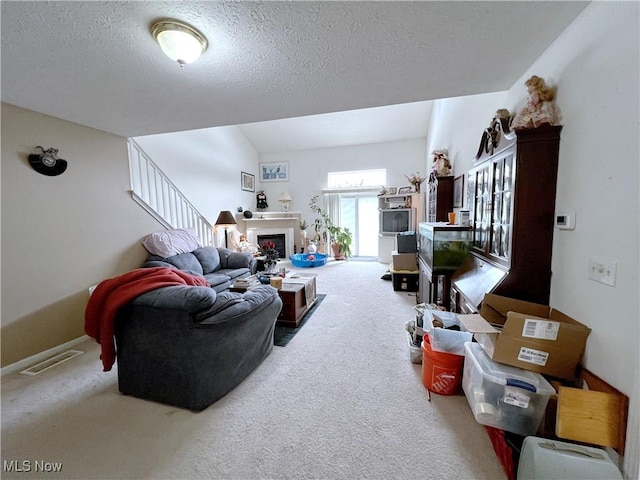 living room with carpet floors and a textured ceiling