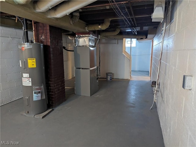 basement featuring heating unit and electric water heater