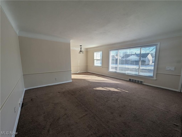 carpeted empty room featuring ornamental molding