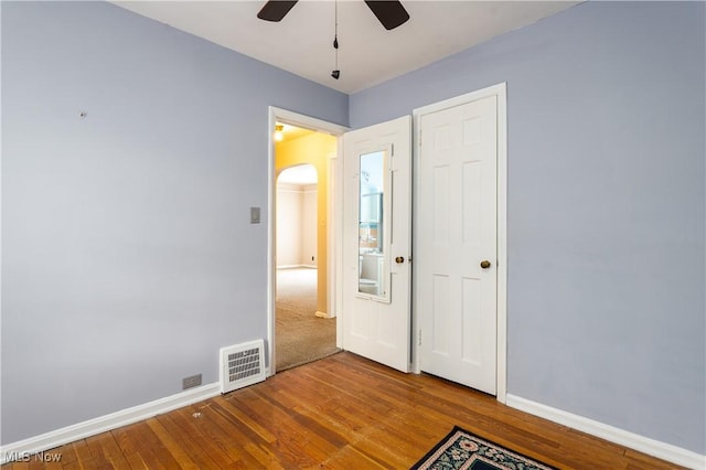 unfurnished bedroom with hardwood / wood-style floors and ceiling fan