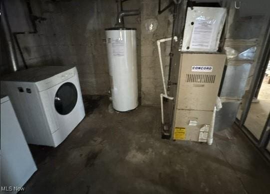 basement featuring heating unit, washer / clothes dryer, and water heater