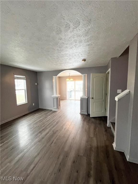 unfurnished living room featuring hardwood / wood-style floors and a textured ceiling