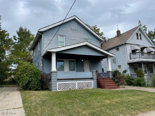 bungalow-style house with a porch and a front lawn