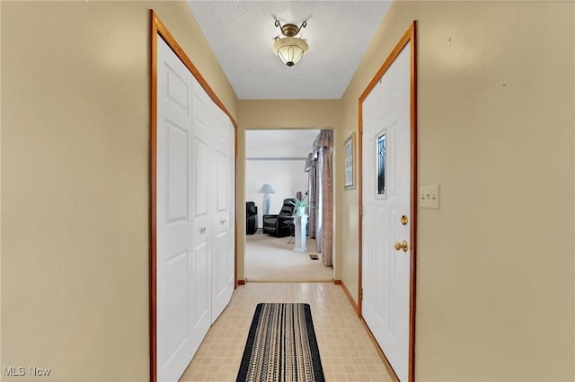 corridor featuring a textured ceiling