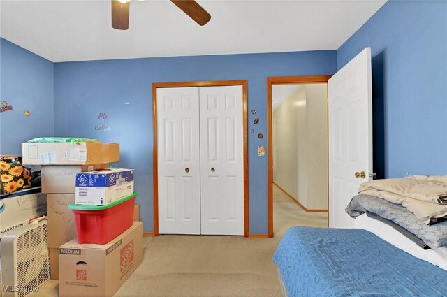 carpeted bedroom with a closet and ceiling fan